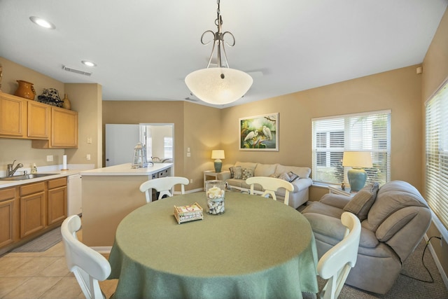 dining space with light tile patterned flooring and sink