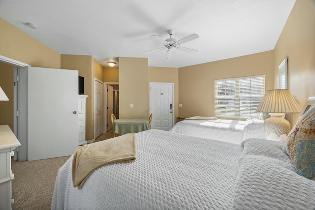 bedroom featuring light colored carpet and ceiling fan