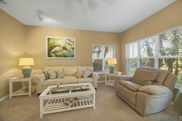 living room with light carpet and ceiling fan