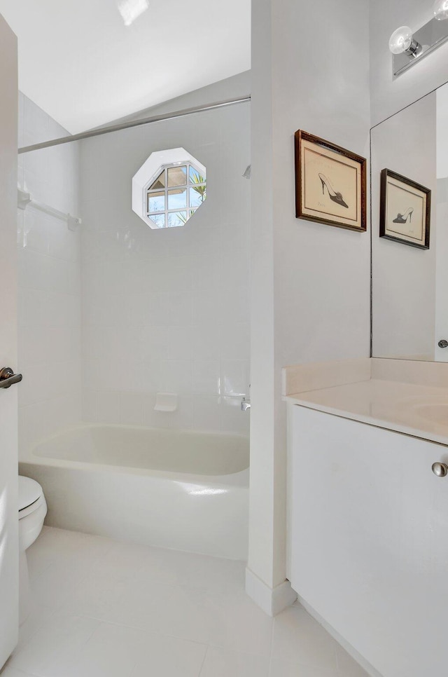 full bathroom with vanity, tiled shower / bath combo, tile patterned floors, and toilet