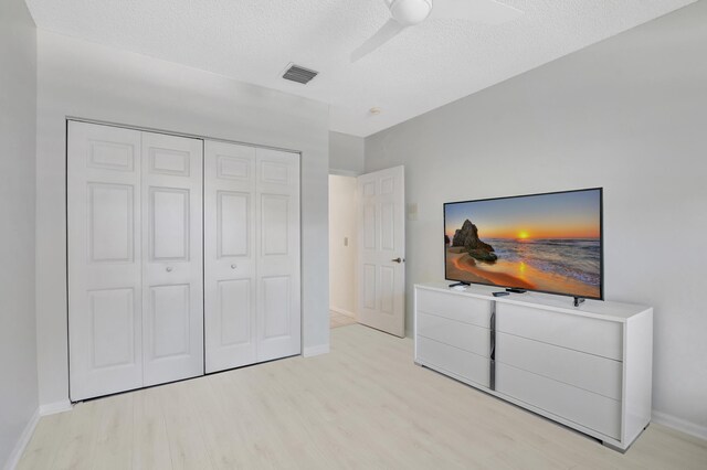 21117 Via Solano, Boca Raton, FL 33433 - bedroom with light wood-style flooring, baseboards, a textured ceiling, and a closet
