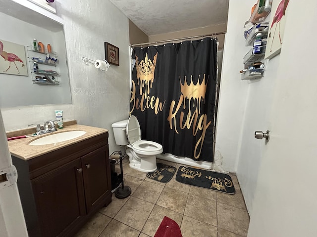 bathroom featuring tile patterned floors, vanity, toilet, and a textured ceiling