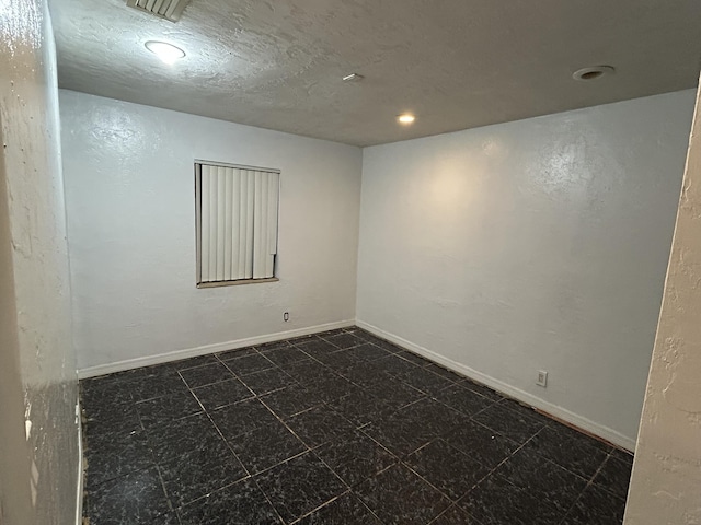 empty room with a textured ceiling