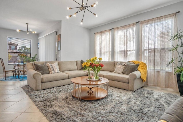 living room featuring a notable chandelier, plenty of natural light, and light tile patterned flooring