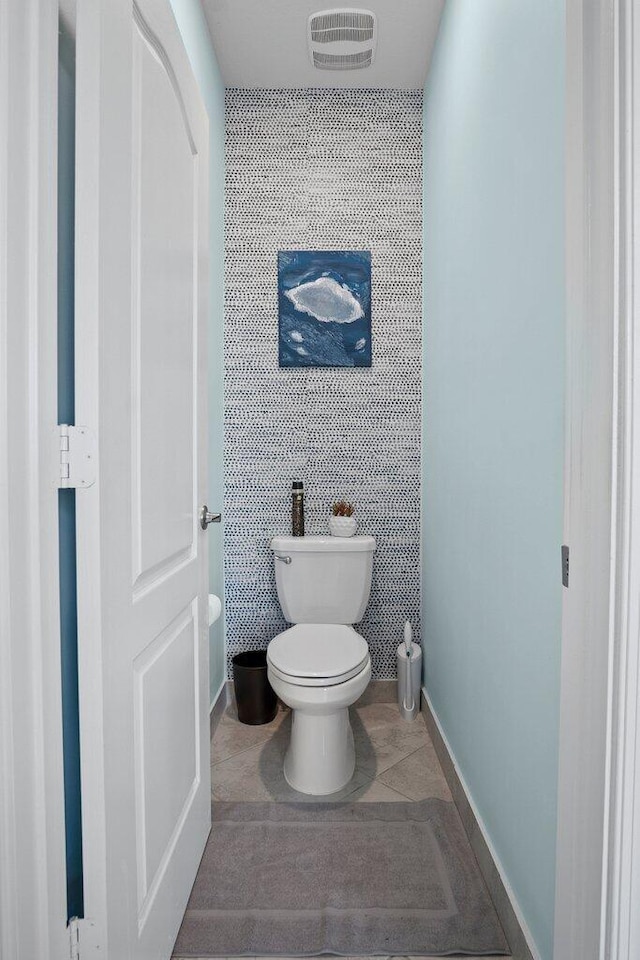 bathroom with toilet and tile patterned flooring