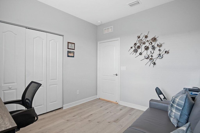 home office with light hardwood / wood-style floors