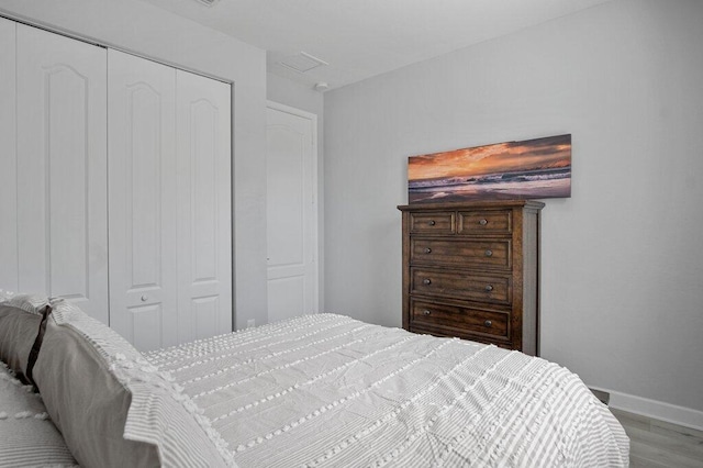 bedroom featuring light hardwood / wood-style floors and a closet