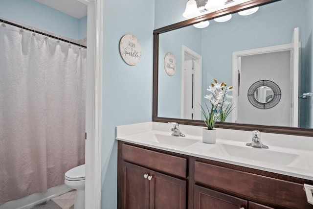 full bathroom featuring vanity, shower / tub combo with curtain, and toilet