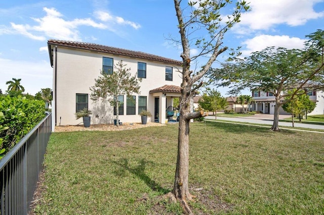 back of house with a lawn