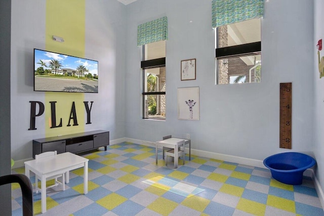 playroom with a towering ceiling