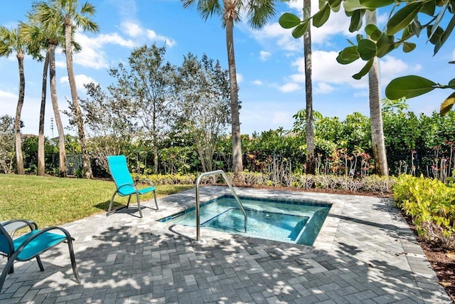 view of pool featuring an in ground hot tub, a yard, and a patio