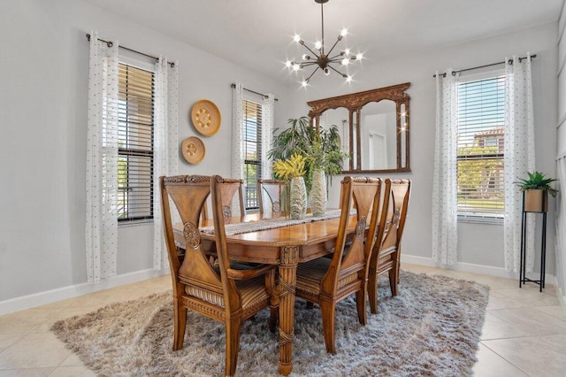 tiled dining space with plenty of natural light and an inviting chandelier