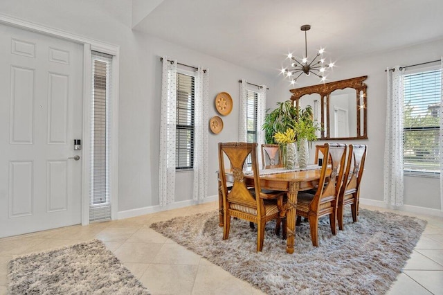 tiled dining room with an inviting chandelier