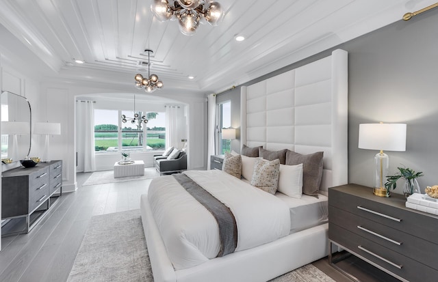 bedroom featuring a raised ceiling, an inviting chandelier, wood ceiling, and light hardwood / wood-style flooring