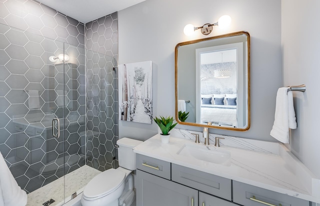 bathroom featuring toilet, a shower with door, and vanity