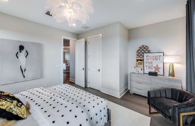 bedroom with dark hardwood / wood-style flooring