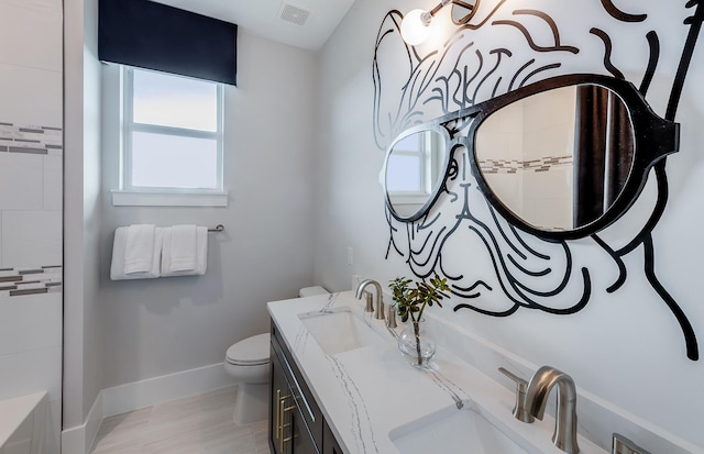 bathroom featuring vanity and toilet