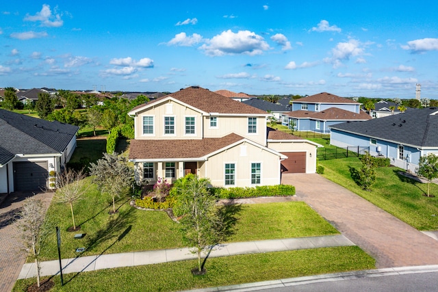 view of front of property with a garage and a front yard