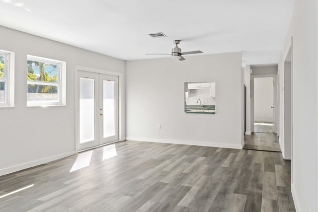 interior space featuring french doors, ceiling fan, sink, and hardwood / wood-style floors