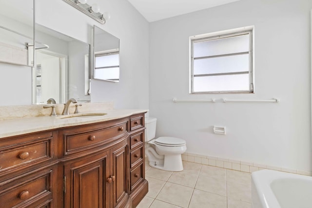 bathroom with vanity, tile patterned floors, a bathtub, and toilet