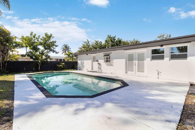 view of swimming pool with a patio and french doors