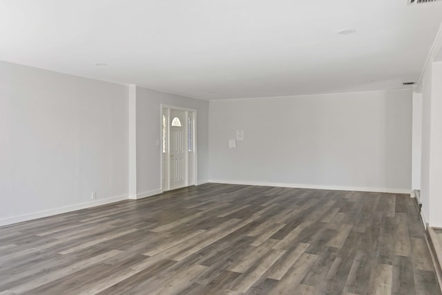 spare room featuring dark wood-type flooring