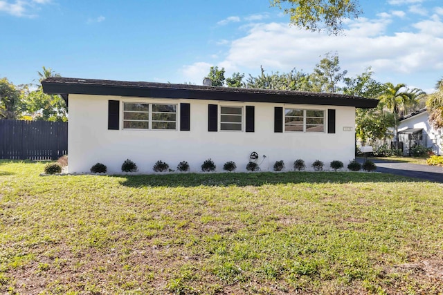 view of side of home with a yard