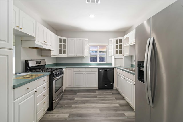 kitchen with stainless steel appliances, white cabinetry, sink, and light hardwood / wood-style flooring