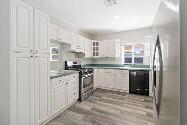 kitchen with light hardwood / wood-style flooring, white cabinets, and appliances with stainless steel finishes