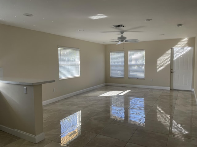 unfurnished room with ceiling fan