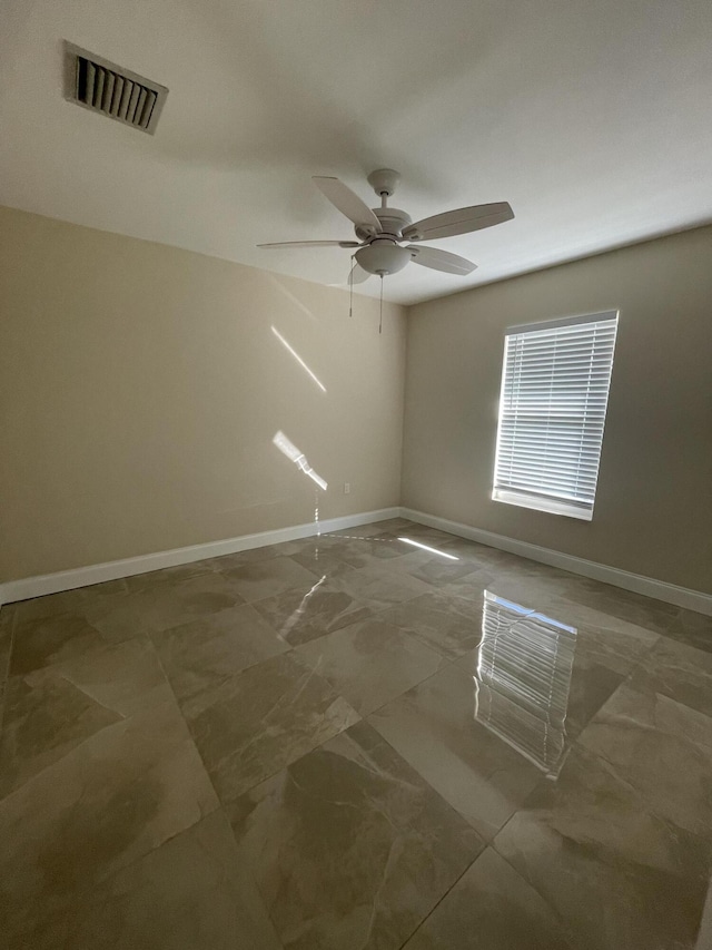 spare room with ceiling fan