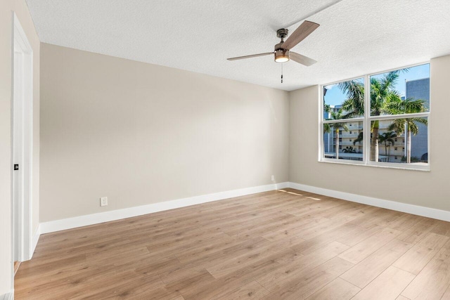 empty room featuring ceiling fan, a textured ceiling, and light hardwood / wood-style floors