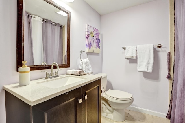 bathroom with tile patterned flooring, vanity, and toilet