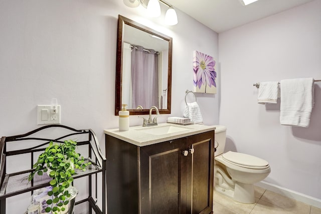 bathroom with tile patterned flooring, vanity, and toilet