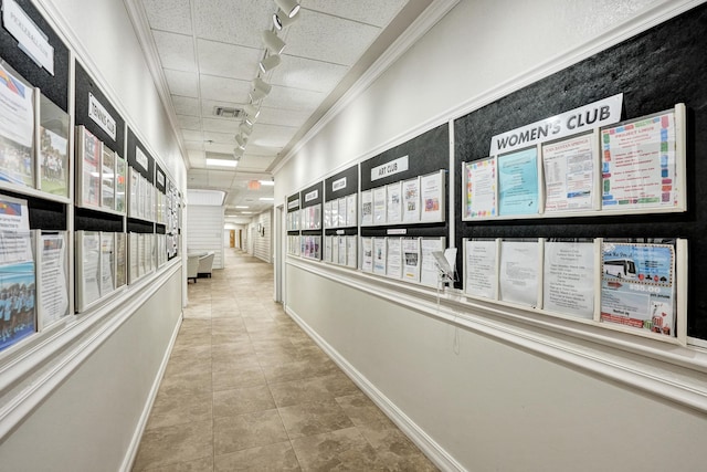 hall with light tile patterned floors and rail lighting