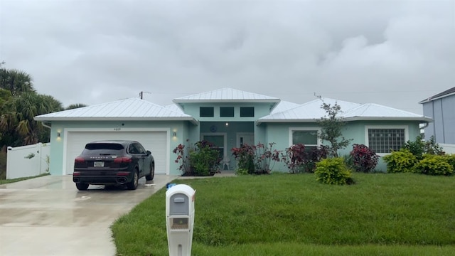 view of front facade featuring a garage and a front lawn