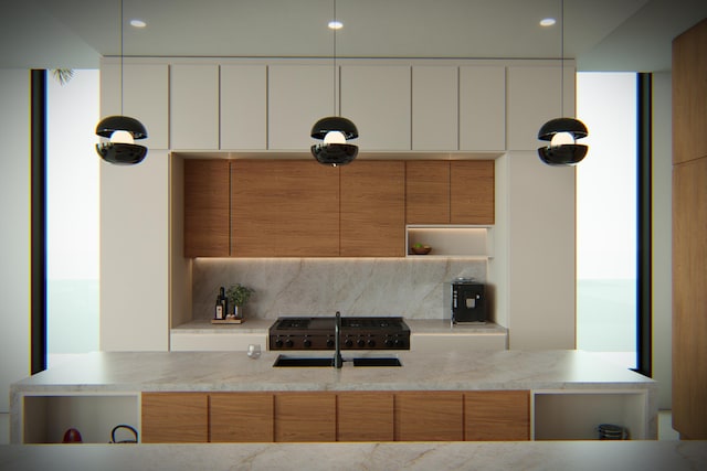 kitchen with white cabinetry, light stone countertops, sink, and decorative backsplash