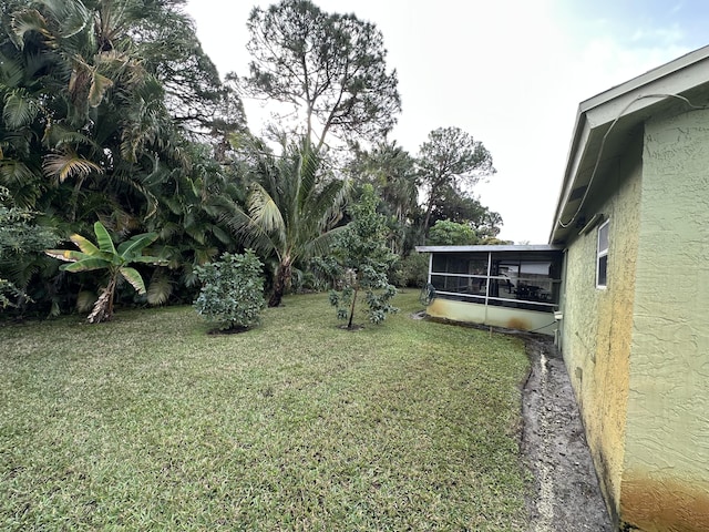 view of yard featuring a sunroom