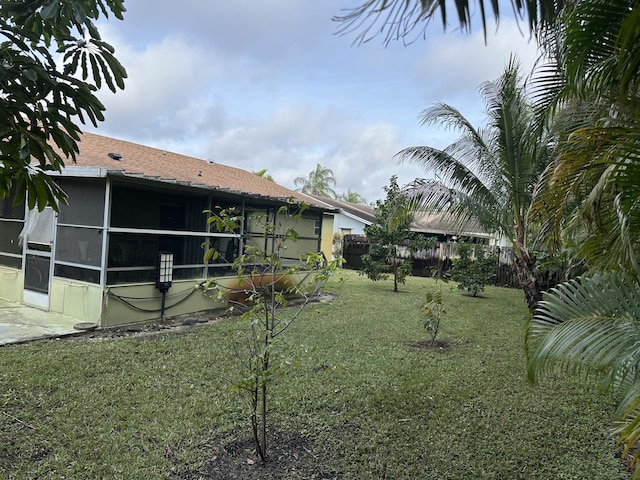 view of yard featuring a sunroom