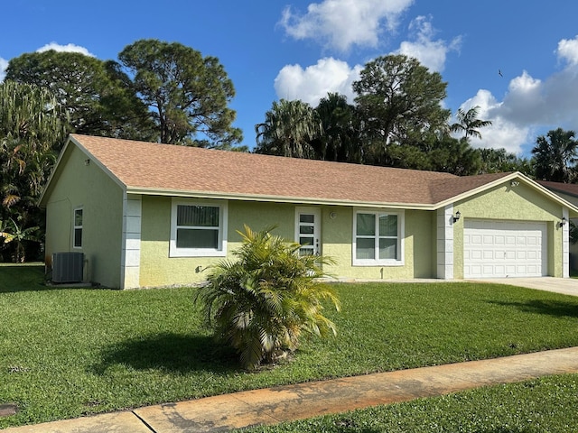 single story home with a garage, a front yard, and central air condition unit