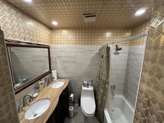 full bathroom with vanity, tile walls, shower / tub combo, and toilet