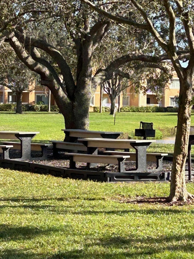 view of property's community with a lawn