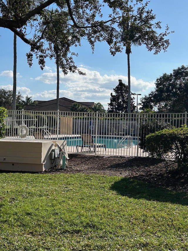 view of pool with a fenced in pool, a yard, and fence