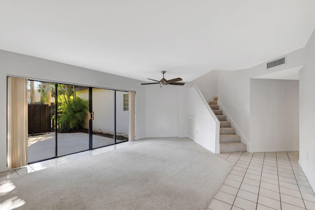 unfurnished living room with ceiling fan and light colored carpet