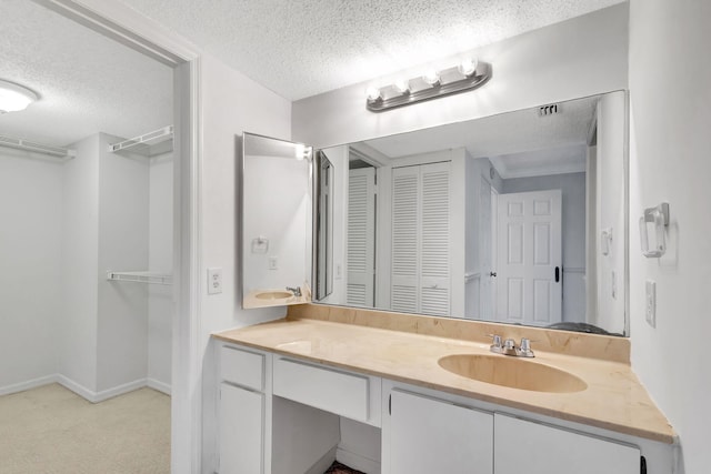 bathroom featuring vanity and a textured ceiling