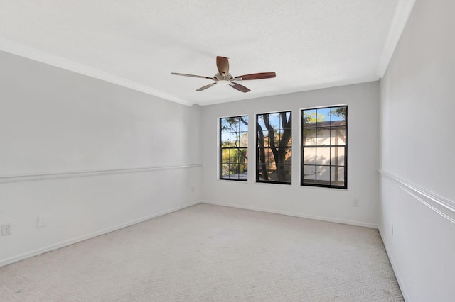 empty room with light carpet, crown molding, a textured ceiling, and ceiling fan