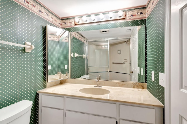 bathroom with vanity, an enclosed shower, and toilet