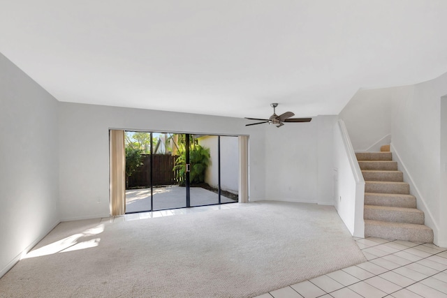 unfurnished living room featuring ceiling fan and light carpet