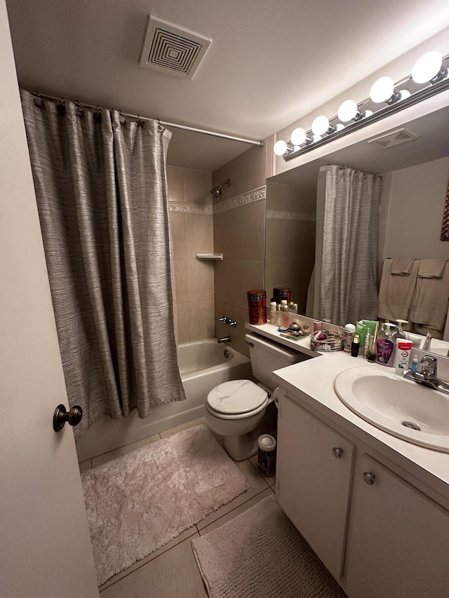 full bathroom featuring tile patterned floors, shower / bath combo with shower curtain, vanity, and toilet