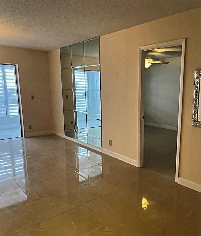 unfurnished room featuring a textured ceiling